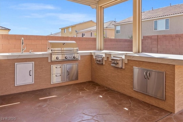 6335 Mount Eden Ave, Las Vegas, NV 89139 - view of patio featuring a grill, a sink, fence, and area for grilling
