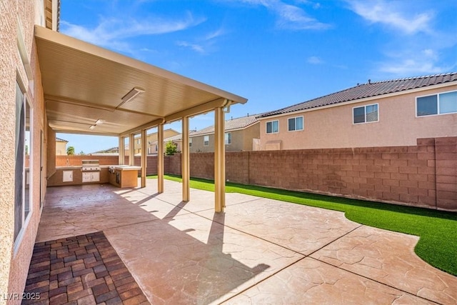 6335 Mount Eden Ave, Las Vegas, NV 89139 - view of patio / terrace featuring exterior kitchen, a fenced backyard, and a grill