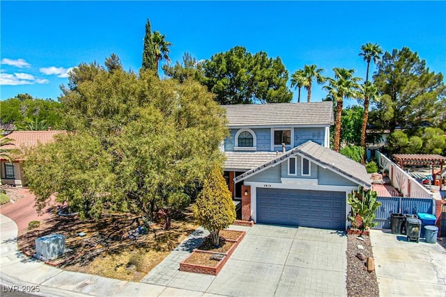 2812 Shadow Creek Cir, Las Vegas, NV 89117 - view of front of home featuring an attached garage, fence, a tiled roof, and concrete driveway