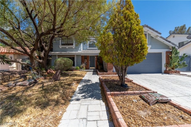 2812 Shadow Creek Cir, Las Vegas, NV 89117 - obstructed view of property featuring a garage, driveway, and brick siding