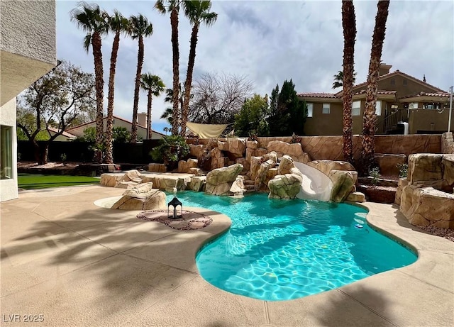 view of swimming pool with fence, a fenced in pool, and a patio area