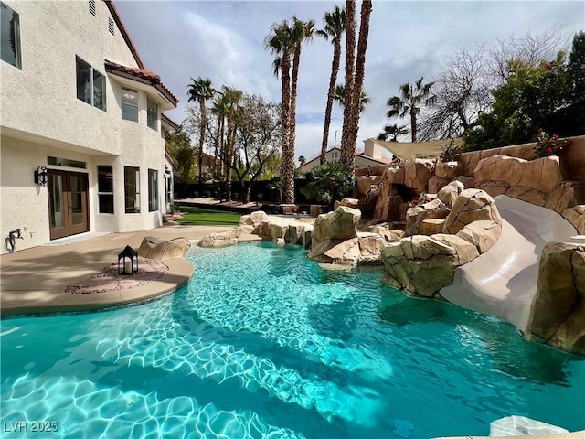 view of swimming pool with a patio and a fenced in pool
