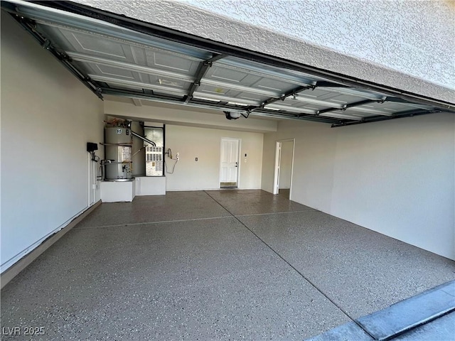 garage featuring heating unit and secured water heater