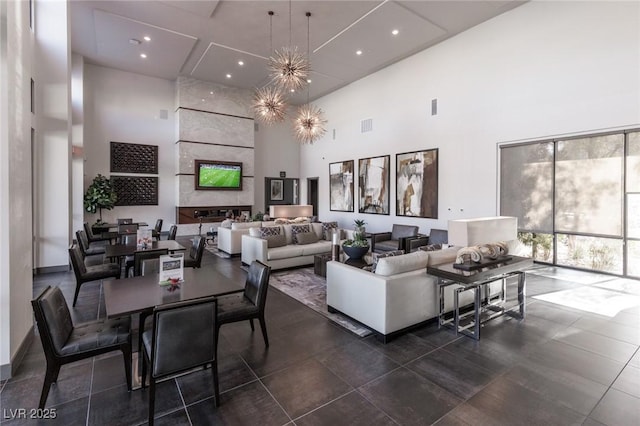 living area with a high ceiling, recessed lighting, and visible vents