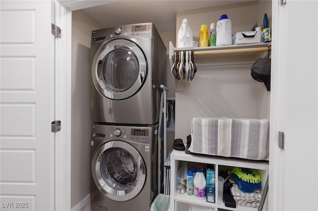 washroom featuring stacked washer / dryer and laundry area