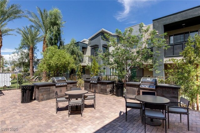 view of patio with a grill, exterior kitchen, and outdoor dining space