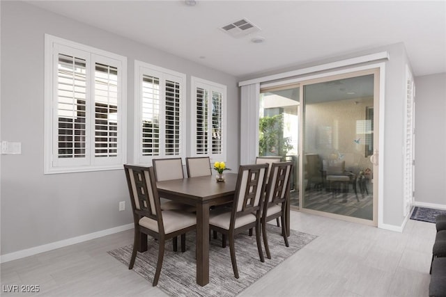 dining room with baseboards and visible vents