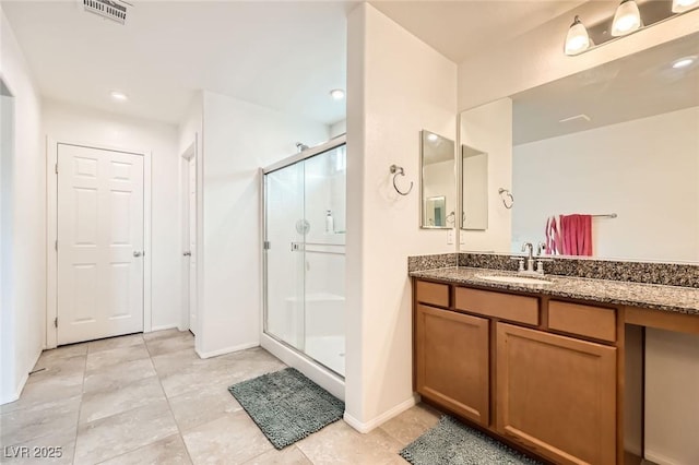 full bathroom with a shower stall, tile patterned floors, vanity, and visible vents