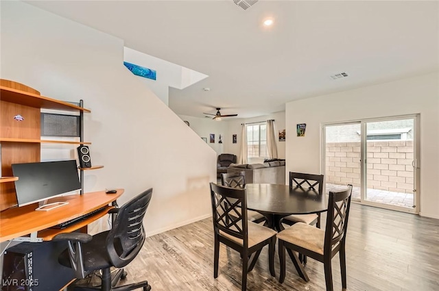 dining area with visible vents, baseboards, a ceiling fan, and wood finished floors