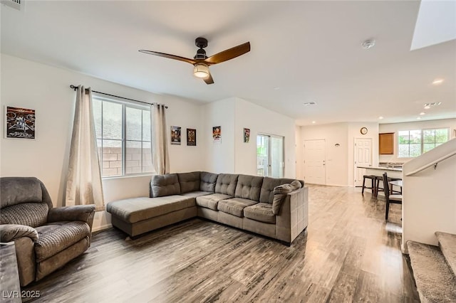 living area featuring ceiling fan, light wood-type flooring, and recessed lighting