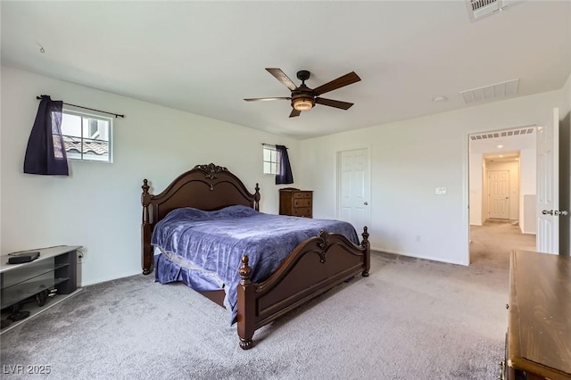 carpeted bedroom with ceiling fan, multiple windows, and visible vents