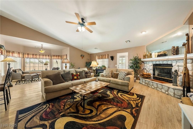 living area featuring ceiling fan, a wealth of natural light, wood finished floors, and lofted ceiling