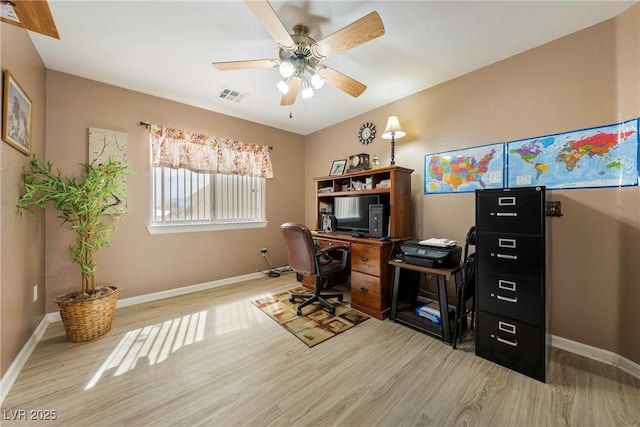 office area with visible vents, baseboards, a ceiling fan, and wood finished floors