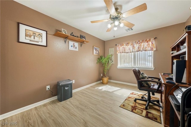 office area featuring wood finished floors, baseboards, a ceiling fan, and visible vents
