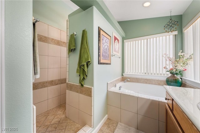 full bathroom featuring a walk in shower, vanity, and a garden tub