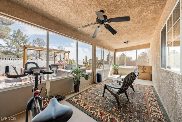 sunroom featuring ceiling fan