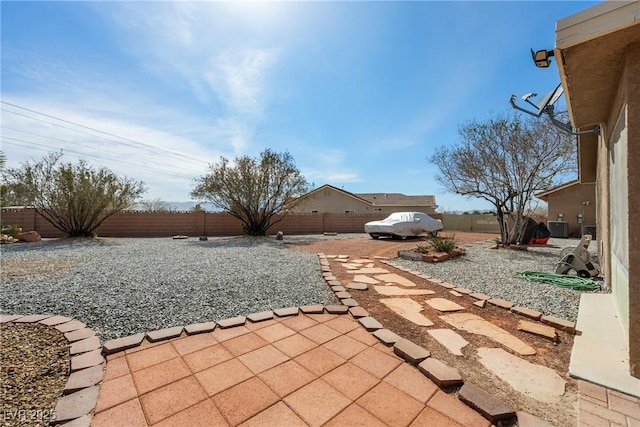 view of patio / terrace with cooling unit and a fenced backyard