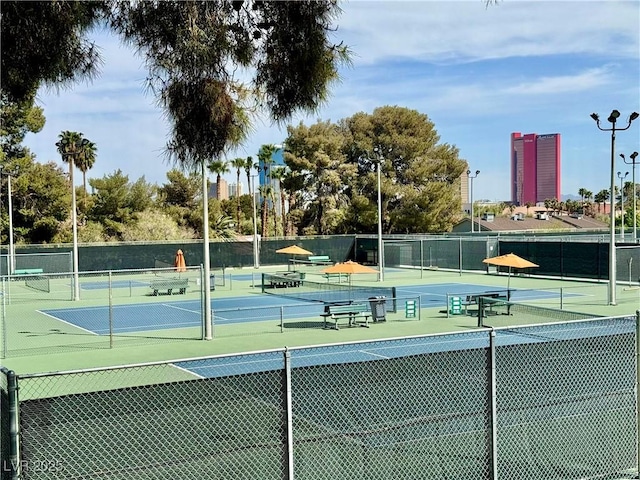 view of sport court featuring fence