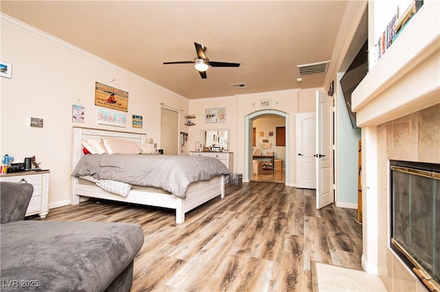 1017 Fairbury St, Henderson, NV 89052 - bedroom with ornamental molding, arched walkways, and wood finished floors