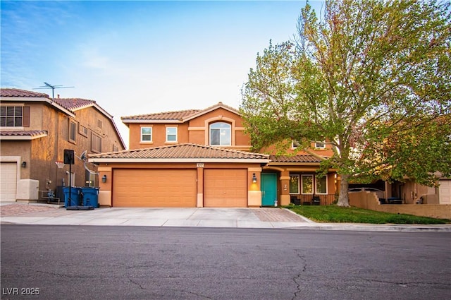 1017 Fairbury St, Henderson, NV 89052 - view of front of house featuring a tiled roof, stucco siding, a garage, and concrete driveway