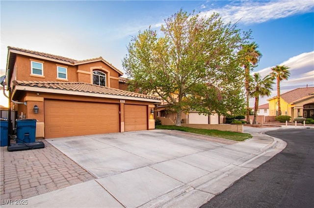 1017 Fairbury St, Henderson, NV 89052 - mediterranean / spanish-style home with a tile roof, stucco siding, an attached garage, and driveway