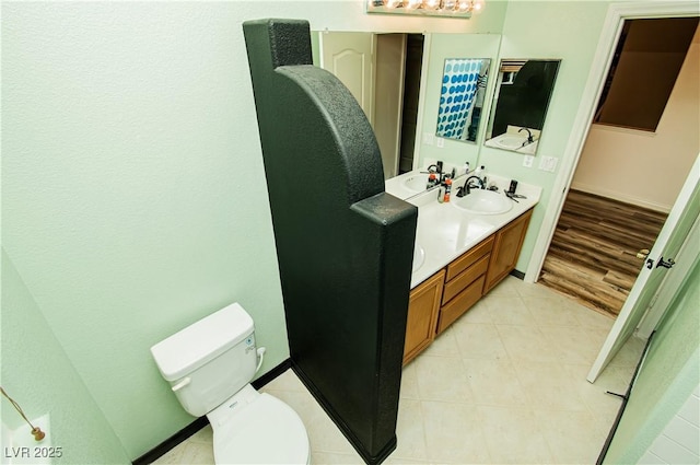1017 Fairbury St, Henderson, NV 89052 - bathroom with baseboards, double vanity, a sink, and toilet