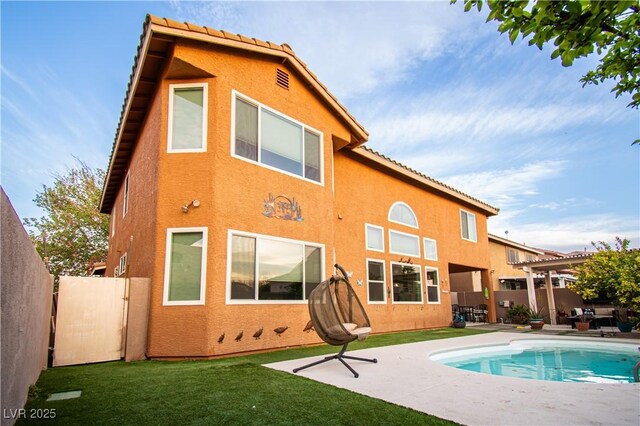 1017 Fairbury St, Henderson, NV 89052 - rear view of house with a tile roof, stucco siding, and a patio