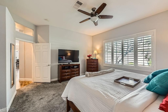 carpeted bedroom featuring ceiling fan, baseboards, and visible vents