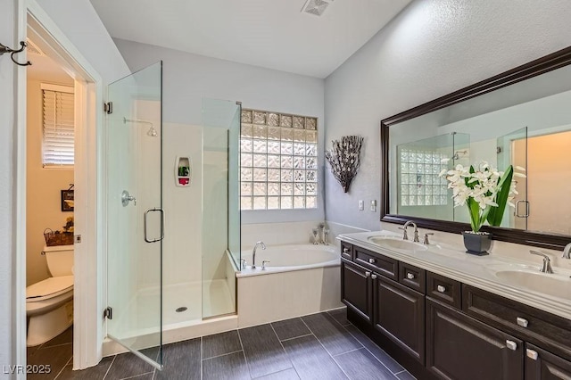 bathroom featuring a sink, visible vents, a bath, and a stall shower