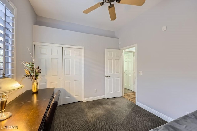 unfurnished bedroom featuring dark carpet, a closet, baseboards, and multiple windows
