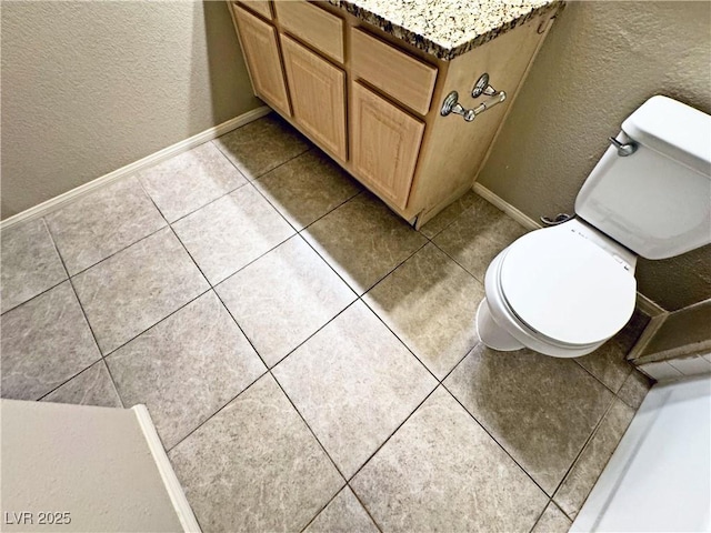 5250 S Rainbow Blvd Unit 1131, Las Vegas, NV 89118 - bathroom featuring a textured wall, toilet, tile patterned flooring, and baseboards