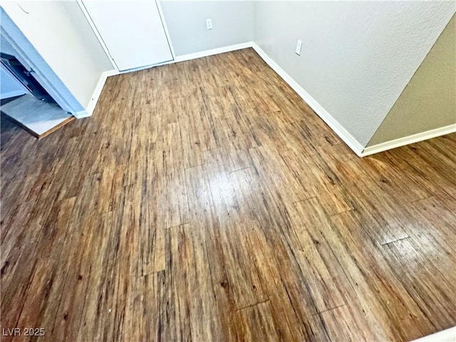 5250 S Rainbow Blvd Unit 1131, Las Vegas, NV 89118 - unfurnished bedroom featuring dark wood-style flooring, baseboards, and a textured wall