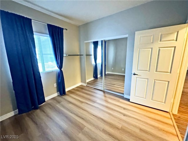 5250 S Rainbow Blvd Unit 1131, Las Vegas, NV 89118 - unfurnished bedroom featuring wood finished floors, baseboards, and a closet