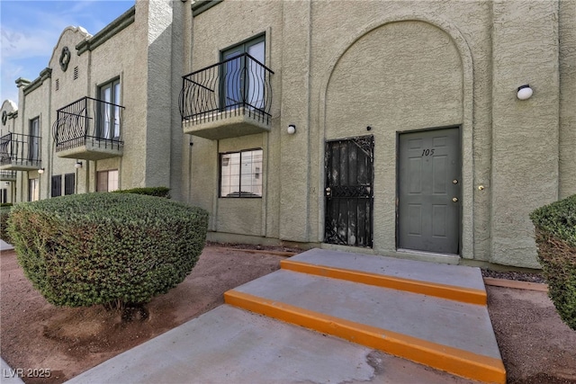entrance to property with stucco siding