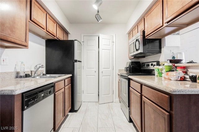 3135 S Mojave Rd Unit 241, Las Vegas, NV 89121 - kitchen with stainless steel microwave, range with electric stovetop, dishwasher, marble finish floor, and a sink