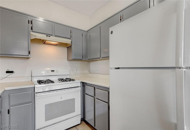 1881 W Alexander Rd Unit 1135, North Las Vegas, NV 89032 - kitchen featuring light countertops, under cabinet range hood, gray cabinetry, and white appliances