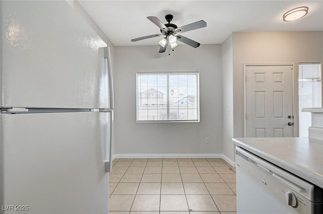 1881 W Alexander Rd Unit 1135, North Las Vegas, NV 89032 - kitchen with light countertops, light tile patterned floors, baseboards, ceiling fan, and freestanding refrigerator