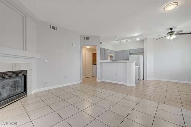 1881 W Alexander Rd Unit 1135, North Las Vegas, NV 89032 - unfurnished living room with a ceiling fan, light tile patterned floors, a fireplace, and visible vents