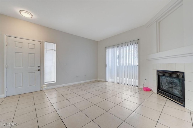 1881 W Alexander Rd Unit 1135, North Las Vegas, NV 89032 - unfurnished living room featuring light tile patterned floors, a tile fireplace, and baseboards