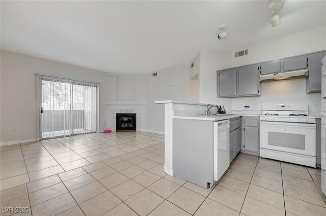 1881 W Alexander Rd Unit 1135, North Las Vegas, NV 89032 - kitchen featuring light tile patterned flooring, visible vents, white appliances, a sink, and gray cabinets