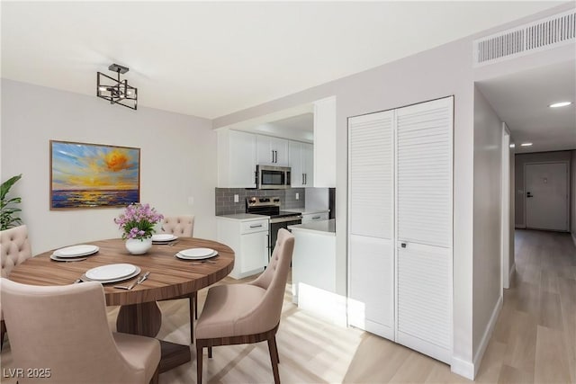 4165 Mississippi Ave, Las Vegas, NV 89103 - dining space with light wood-style floors and baseboards