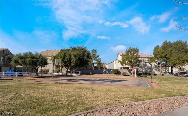 view of community with a yard, a residential view, and community basketball court