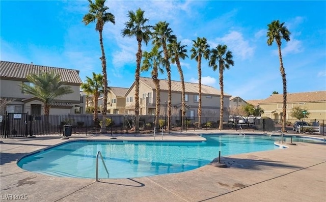 pool featuring a residential view, a patio area, and fence