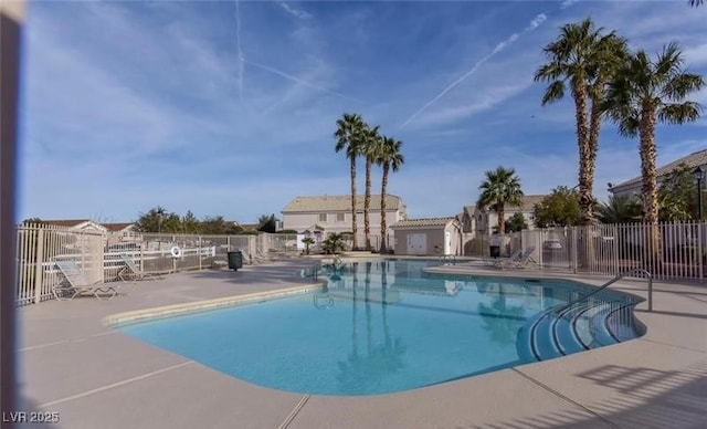pool featuring a patio area and fence
