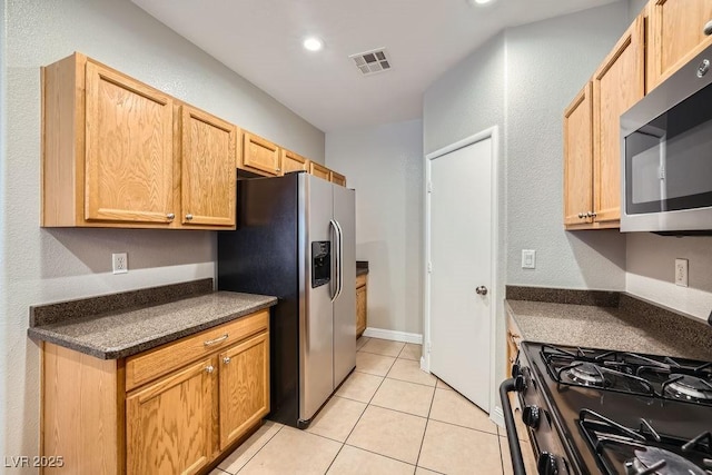 kitchen with visible vents, recessed lighting, appliances with stainless steel finishes, light tile patterned flooring, and dark countertops