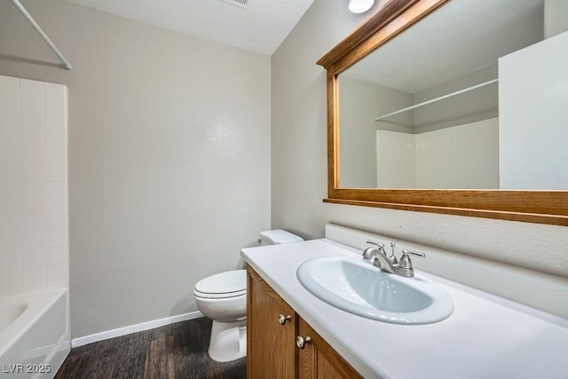 full bath featuring vanity, baseboards, toilet, bathtub / shower combination, and wood finished floors