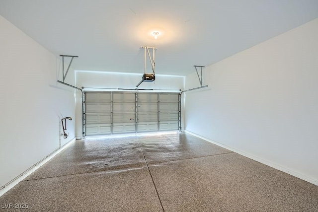 garage with baseboards and a garage door opener