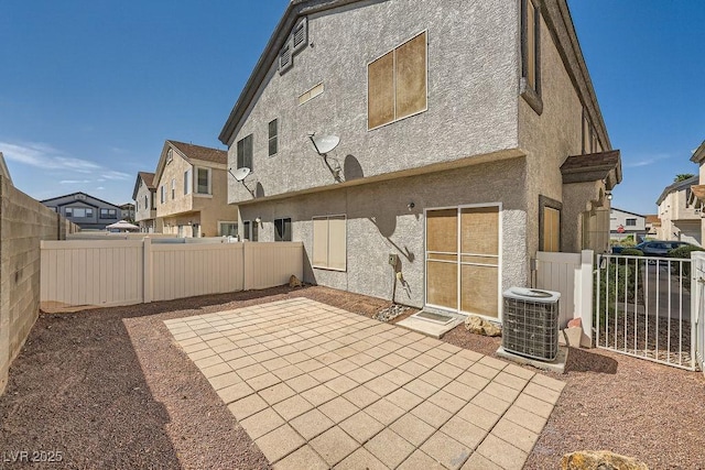 rear view of property featuring a patio, a fenced backyard, stucco siding, and a residential view