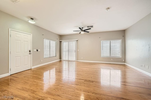 unfurnished living room with visible vents, ceiling fan, light wood finished floors, and baseboards