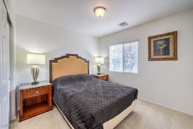 bedroom with a closet, baseboards, visible vents, and light colored carpet
